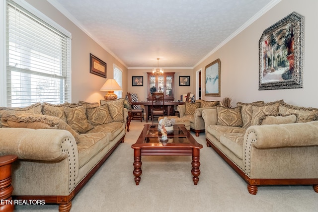 living room with ornamental molding, carpet floors, a notable chandelier, and a textured ceiling