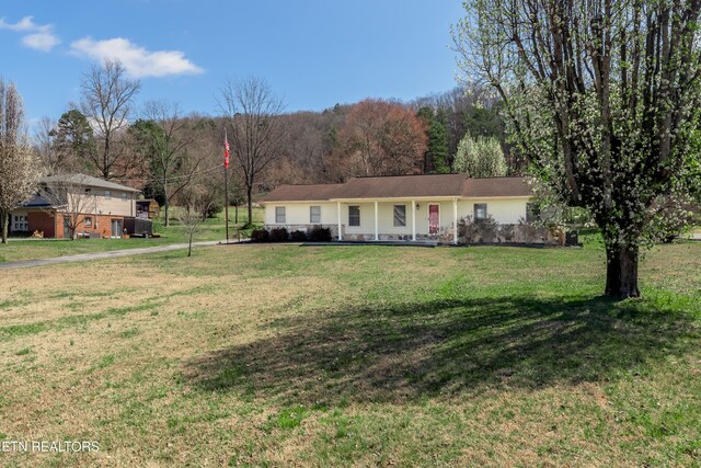 ranch-style home featuring a front yard and an attached garage