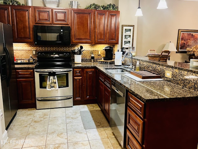 kitchen featuring black appliances, tasteful backsplash, a sink, and a peninsula