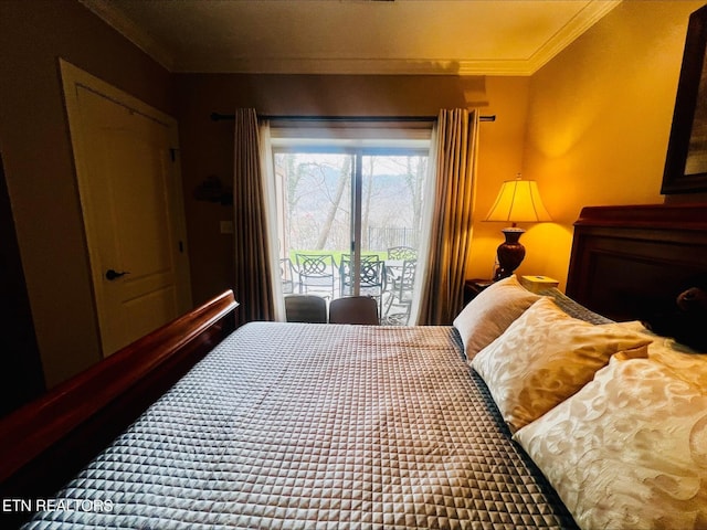 bedroom with ornamental molding and access to exterior