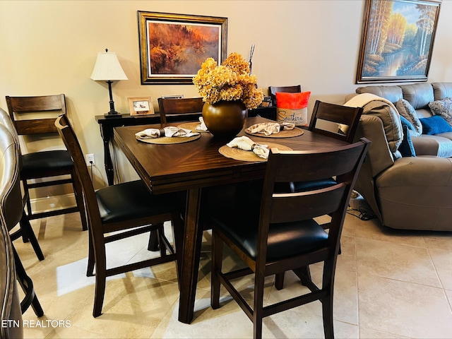 dining area featuring light tile patterned floors