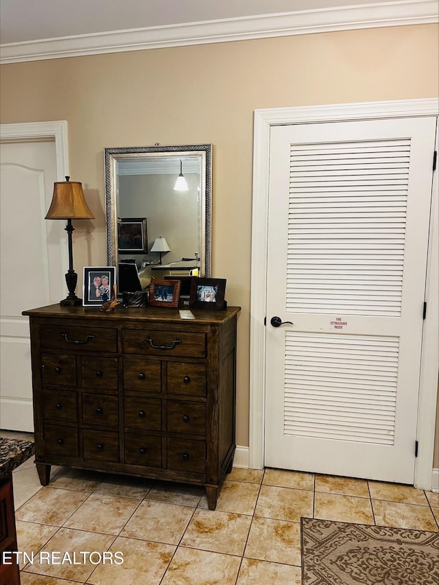 bedroom with crown molding and light tile patterned floors