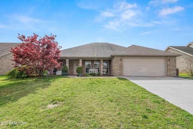 view of front of property featuring a front yard, an attached garage, brick siding, driveway, and roof with shingles