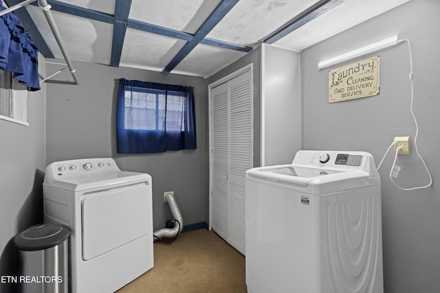 laundry area featuring carpet flooring, washer and clothes dryer, and laundry area