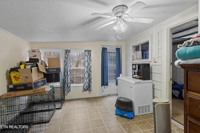 laundry room with tile patterned flooring, crown molding, ceiling fan, and a textured ceiling