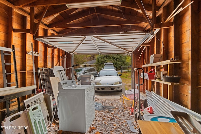exterior space with an attached carport and washer / dryer