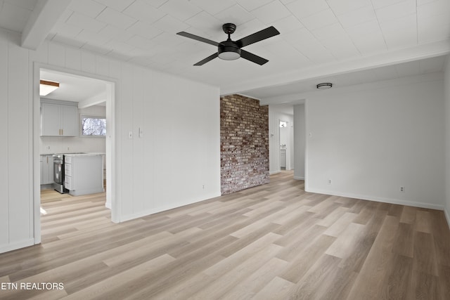 unfurnished living room with light wood-type flooring, baseboards, beam ceiling, and ceiling fan