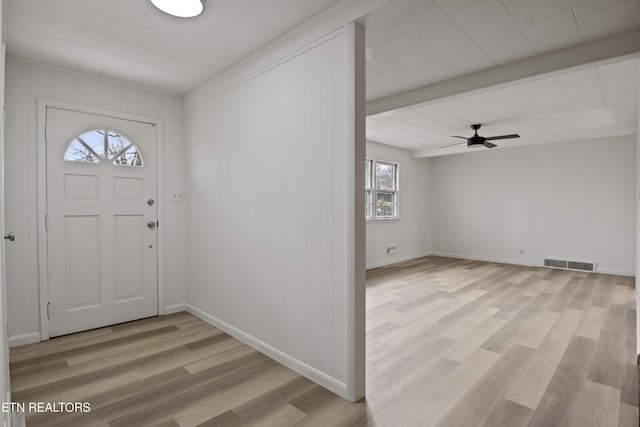 foyer entrance with light wood-style flooring, baseboards, visible vents, beamed ceiling, and a ceiling fan