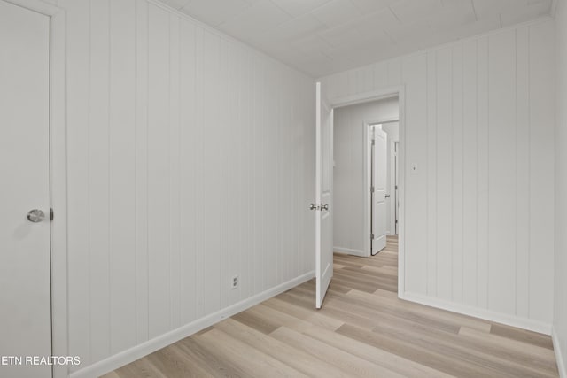 unfurnished bedroom with light wood finished floors and baseboards