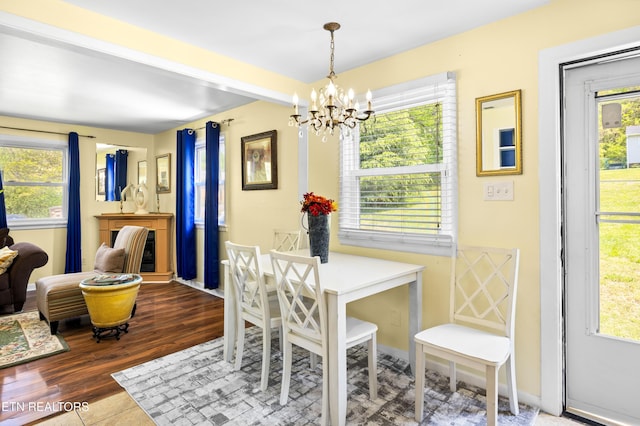 dining area featuring plenty of natural light and a notable chandelier