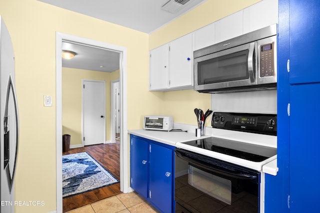 kitchen with a toaster, light countertops, visible vents, appliances with stainless steel finishes, and white cabinetry