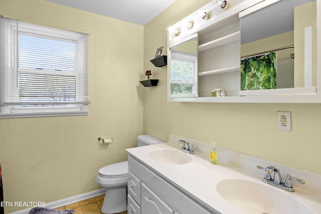 full bath with toilet, tile patterned flooring, a sink, and baseboards