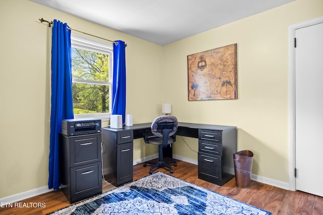 office featuring baseboards and dark wood-style flooring