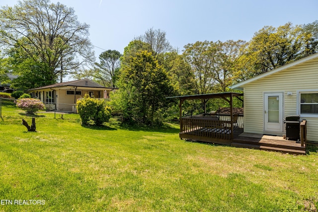 view of yard featuring fence and a deck