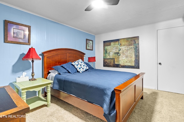 carpeted bedroom featuring a ceiling fan and ornamental molding
