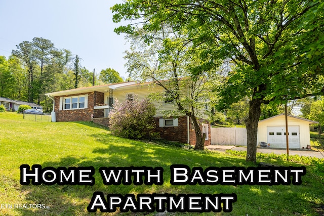 view of front of property featuring a front lawn, brick siding, and a detached garage
