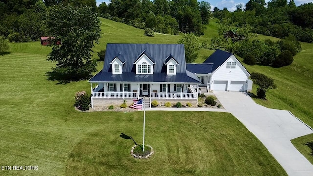277 Deerfield Way, Lafollette, TN 37766 - new england style home with covered porch, driveway, a front yard, and metal roof