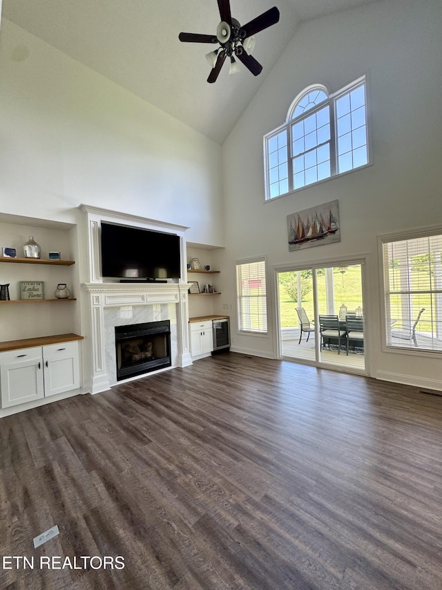277 Deerfield Way, Lafollette, TN 37766 - unfurnished living room featuring a premium fireplace, high vaulted ceiling, ceiling fan, dark wood finished floors, and healthy amount of natural light