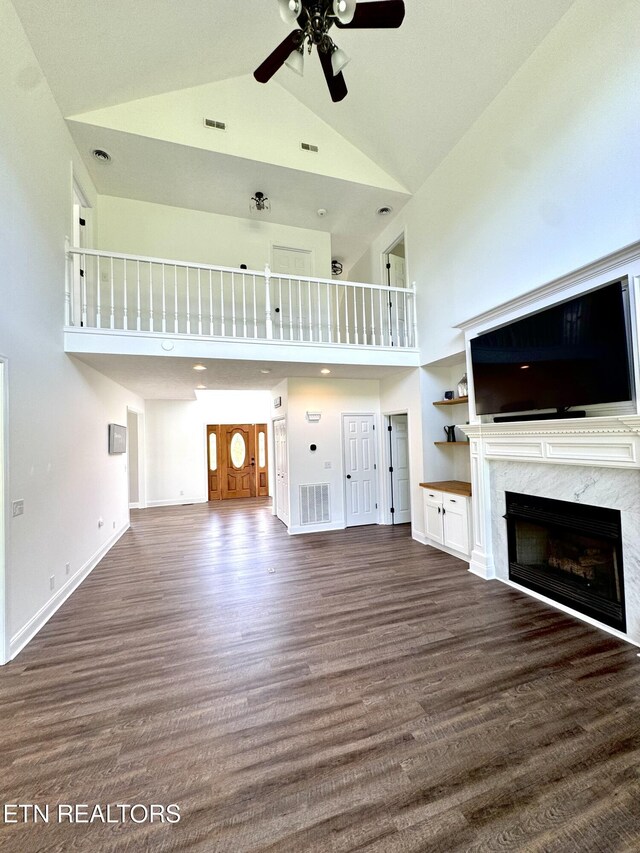 277 Deerfield Way, Lafollette, TN 37766 - unfurnished living room with high vaulted ceiling, a ceiling fan, a high end fireplace, wood finished floors, and baseboards