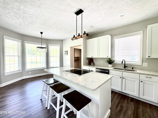 277 Deerfield Way, Lafollette, TN 37766 - kitchen featuring black electric stovetop, a sink, a textured ceiling, dark wood-style flooring, and a kitchen island