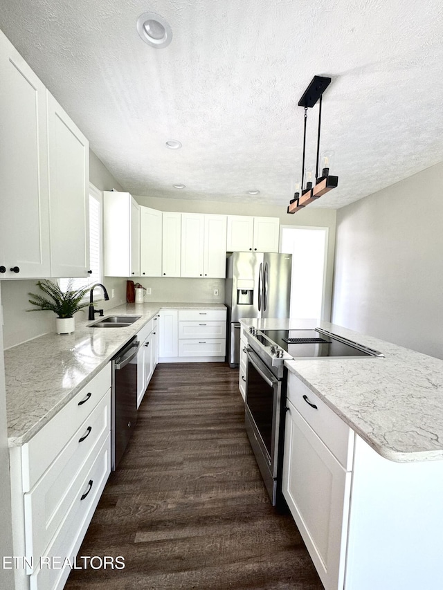 277 Deerfield Way, Lafollette, TN 37766 - kitchen featuring appliances with stainless steel finishes, a sink, dark wood-type flooring, a center island, and white cabinets