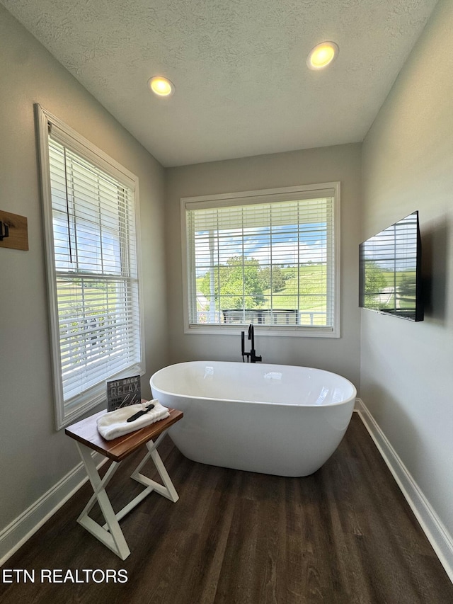 277 Deerfield Way, Lafollette, TN 37766 - full bath featuring wood finished floors, baseboards, a soaking tub, a textured ceiling, and recessed lighting
