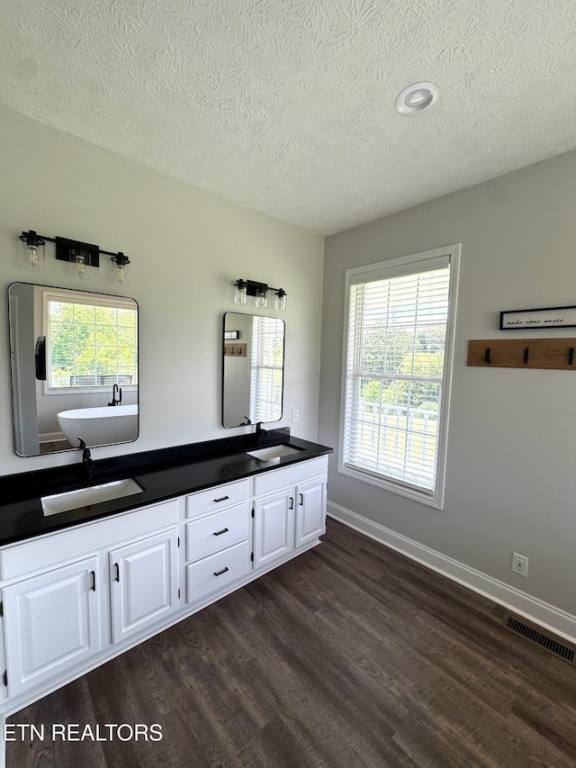 277 Deerfield Way, Lafollette, TN 37766 - bathroom with wood finished floors, a textured ceiling, double vanity, and baseboards