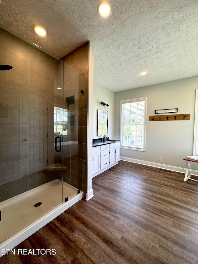277 Deerfield Way, Lafollette, TN 37766 - full bathroom with wood finished floors, baseboards, a textured ceiling, a shower stall, and vanity