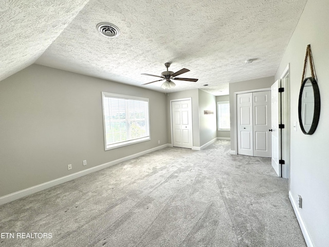 277 Deerfield Way, Lafollette, TN 37766 - unfurnished bedroom featuring multiple closets, carpet floors, multiple windows, baseboards, and a textured ceiling