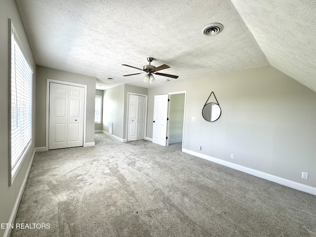 277 Deerfield Way, Lafollette, TN 37766 - unfurnished bedroom featuring multiple closets, baseboards, carpet, and a textured ceiling