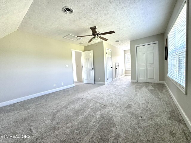 277 Deerfield Way, Lafollette, TN 37766 - unfurnished bedroom with multiple closets, carpet floors, a textured ceiling, baseboards, and attic access