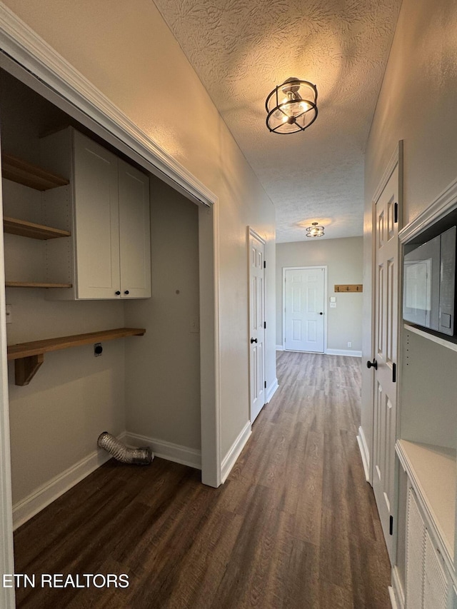 277 Deerfield Way, Lafollette, TN 37766 - clothes washing area with electric dryer hookup, dark wood-style floors, cabinet space, baseboards, and a textured ceiling