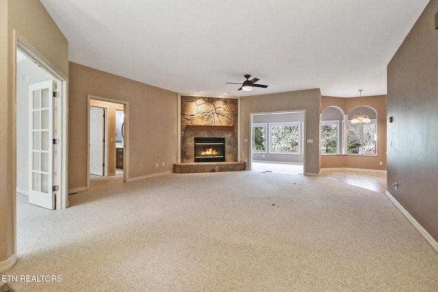 18 Inwood Dr, Fairfield Glade, TN 38558 - unfurnished living room featuring a fireplace, baseboards, ceiling fan with notable chandelier, visible vents, and carpet