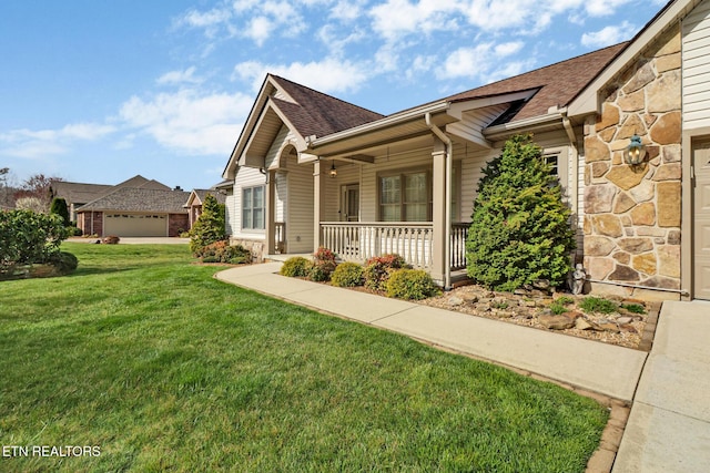18 Inwood Dr, Fairfield Glade, TN 38558 - view of front facade featuring stone siding, a shingled roof, a porch, and a front yard