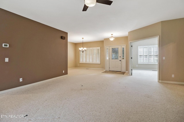 18 Inwood Dr, Fairfield Glade, TN 38558 - unfurnished living room featuring carpet floors, ceiling fan with notable chandelier, and baseboards