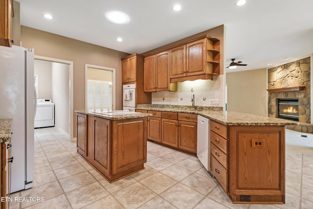 18 Inwood Dr, Fairfield Glade, TN 38558 - kitchen featuring white appliances, washer / clothes dryer, a ceiling fan, open floor plan, and brown cabinetry