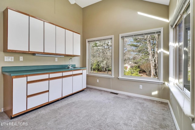 18 Inwood Dr, Fairfield Glade, TN 38558 - kitchen with white cabinetry, baseboards, a sink, visible vents, and light carpet
