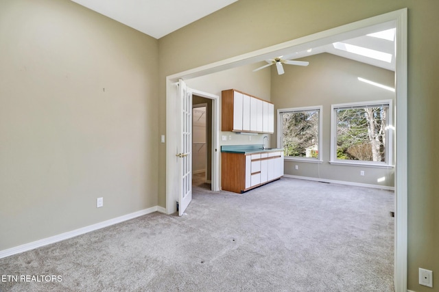 18 Inwood Dr, Fairfield Glade, TN 38558 - unfurnished bedroom with light colored carpet, high vaulted ceiling, a skylight, and baseboards