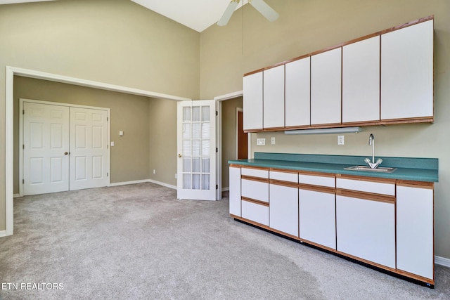 18 Inwood Dr, Fairfield Glade, TN 38558 - kitchen featuring high vaulted ceiling, a sink, light colored carpet, white cabinets, and ceiling fan