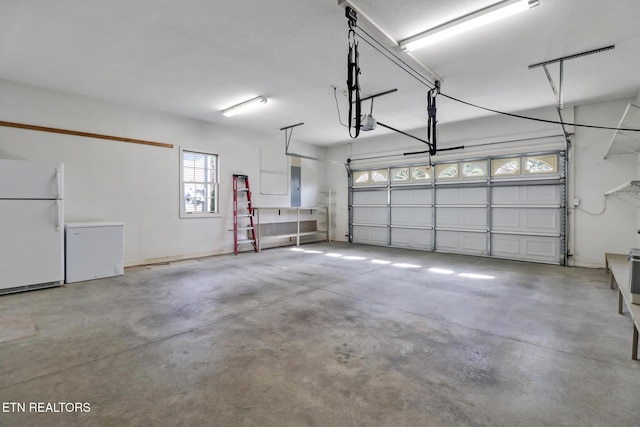 18 Inwood Dr, Fairfield Glade, TN 38558 - garage featuring electric panel, fridge, a garage door opener, and freestanding refrigerator