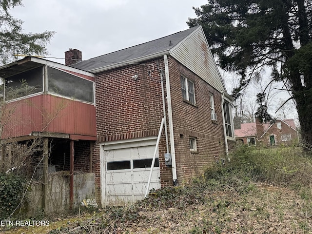 108 W Red Bud Rd, Knoxville, TN 37920 - view of home's exterior with an attached garage, a chimney, and brick siding