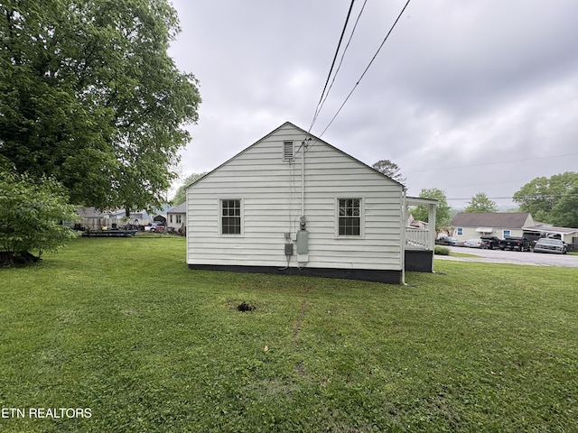 view of property exterior with a yard