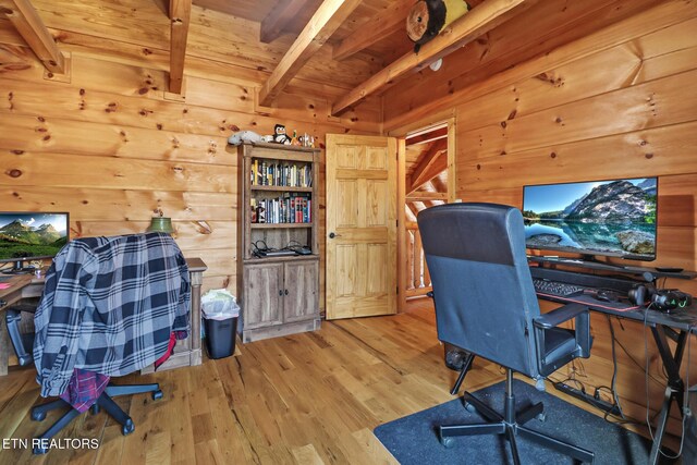 home office featuring beamed ceiling, wood walls, wooden ceiling, and wood finished floors