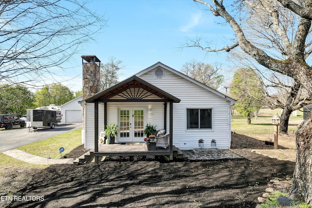 1533 Middlesettlements Rd, Maryville, TN 37801 - rear view of house featuring french doors, an outdoor structure, a garage, and a chimney