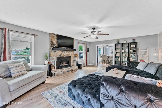 1533 Middlesettlements Rd, Maryville, TN 37801 - living room featuring a stone fireplace, a ceiling fan, and wood finished floors