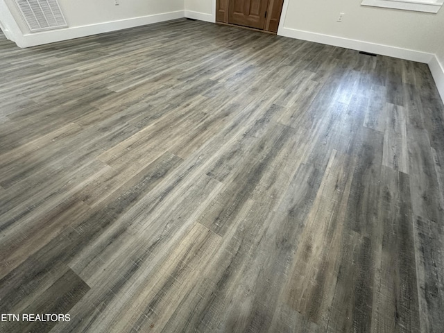 room details featuring visible vents, baseboards, and wood finished floors