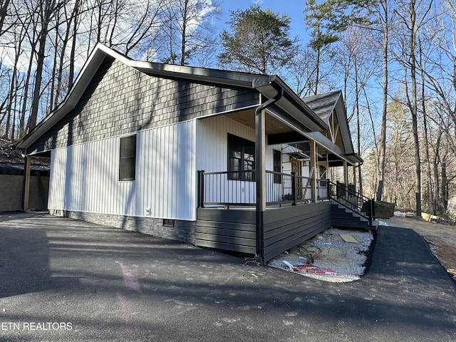 view of home's exterior featuring a porch and crawl space