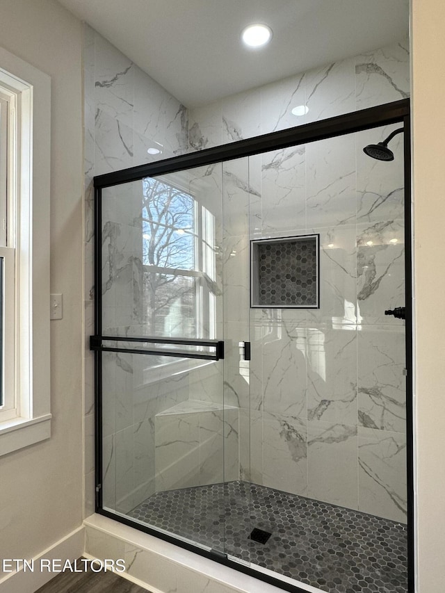 full bath with a marble finish shower and recessed lighting