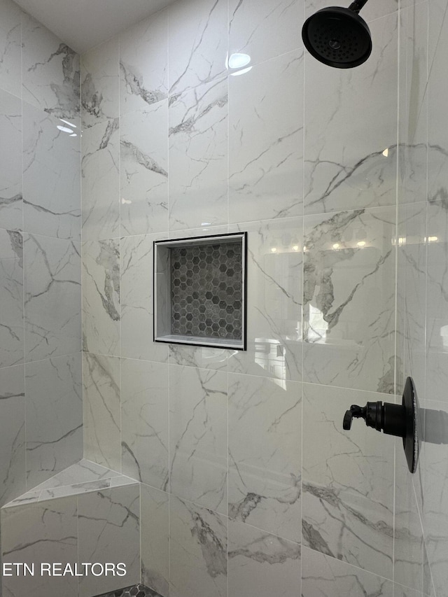 bathroom with a tile shower