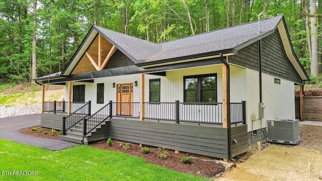 520 Ridge Rd, Caryville, TN 37714 - modern farmhouse with covered porch, central air condition unit, and roof with shingles